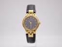 Tissot Stylist women's watch, front view, black dial and gold-tone case.