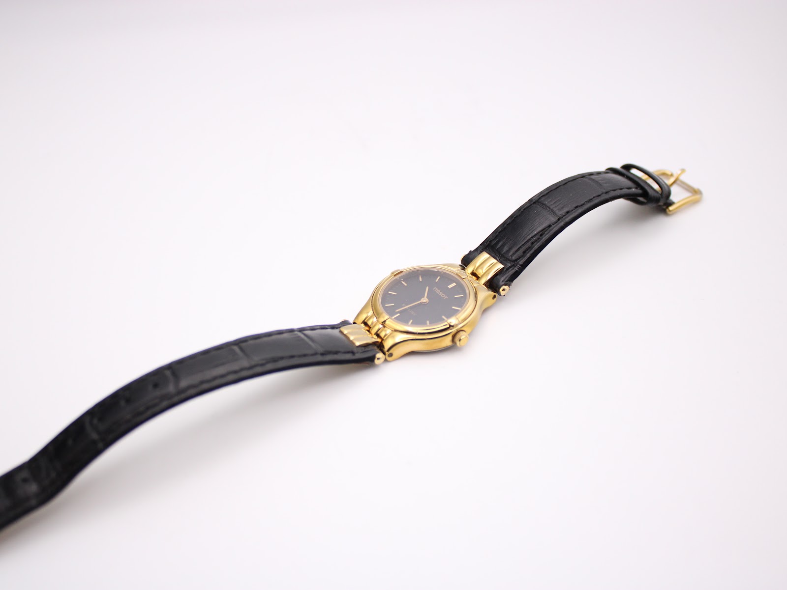 Rear view of Tissot Stylist gold-tone case.