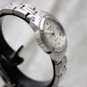 Close-up of the Tissot PR 100 stainless steel bracelet and signed clasp.