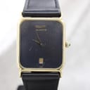 Front view of Tissot vintage quartz dress watch with black dial and gold-tone rectangular case.