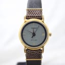 Front view of vintage Tissot Stylist ladies' watch, showing textured grey dial, gold-tone case, and brown leather strap.