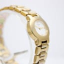 Angled view of the Tissot G331K gold watch, showing the left side of the case and integrated bracelet.