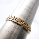 Close-up of the Tissot gold-tone bracelet on a wrist sizer, indicating a fit of approximately 160mm.