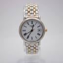 Front view of the Tissot 1853 ladies' watch with a white dial, Roman numerals, date window, and two-tone bracelet.