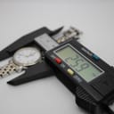 Digital caliper displaying a measurement of 25.9 mm across the watch case, indicating its diameter.