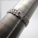 The watch bracelet closed around a wrist sizing gauge, showing a fit for approximately 150mm (15cm) wrist circumference.