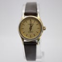 Front view of the Tissot Seastar quartz watch with champagne dial, gold-tone case, and dark brown leather strap.