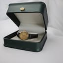 The Tissot Seastar watch displayed within an open, dark green watch presentation box with a gold crown emblem.