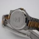 Close-up of the watch case back, revealing "TISSOT", "MINERAL CRYSTAL", "WATERRESISTANT 30 M", "STAINLESS STEEL", and "D 317" engravings, with a view of the clasp.
