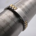 The watch bracelet wrapped around a wrist sizing gauge, showing a fit of approximately 160mm. The signed fold-over clasp is clearly visible.