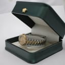 The Tissot Seastar watch displayed inside a dark green, unbranded watch presentation box with a cream interior.