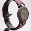 Another angled side view of the Tissot Rock Watch, showing the minimalist dial and the smooth, rounded profile of the stone case.