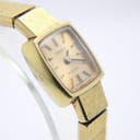 Front view of the gold Tissot Stylist dial with champagne sunburst finish and gold baton indices.