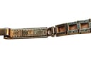 Extreme close-up of the bracelet clasp, showing 'TISSOT PLAQUE OR G 10 MICRONS'.