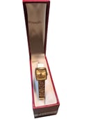 The watch displayed in a vintage H. Samuel red watch box.
