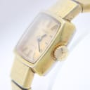 Close-up of the watch dial and signed crown with 'T' logo.