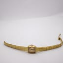 Full length view of the watch laid flat, displaying the integrated bracelet.