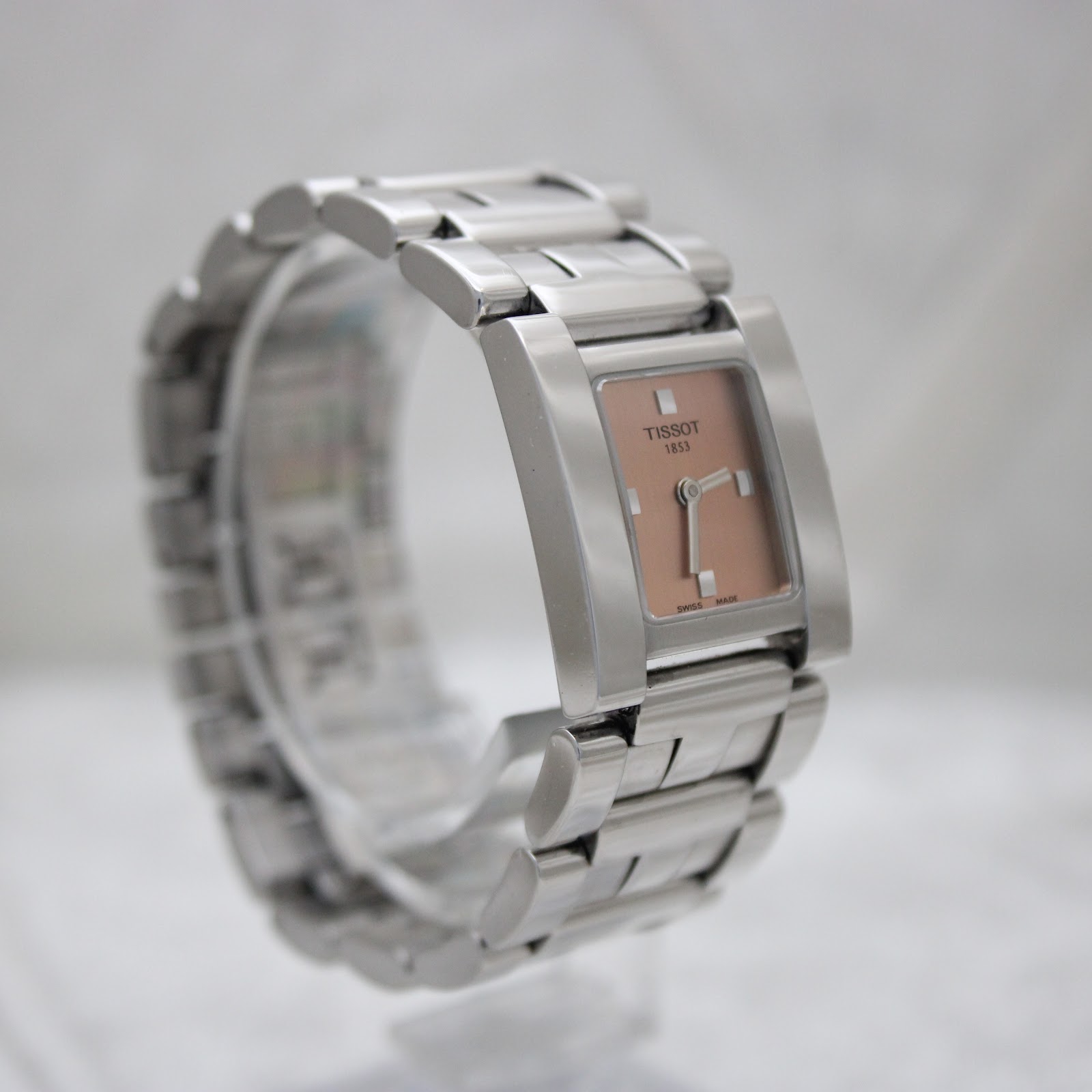 Left side angle view of the Tissot square watch showcasing the elegant case and bracelet design.