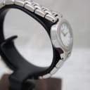 Angled side view of the Tissot G334 watch, showing the integrated stainless steel bracelet design and the curvature of the case.