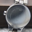 Close-up of the Tissot G334 case back, clearly showing engravings for Tissot 1853, G334 model, serial number, sapphire crystal, and 30m water resistance.