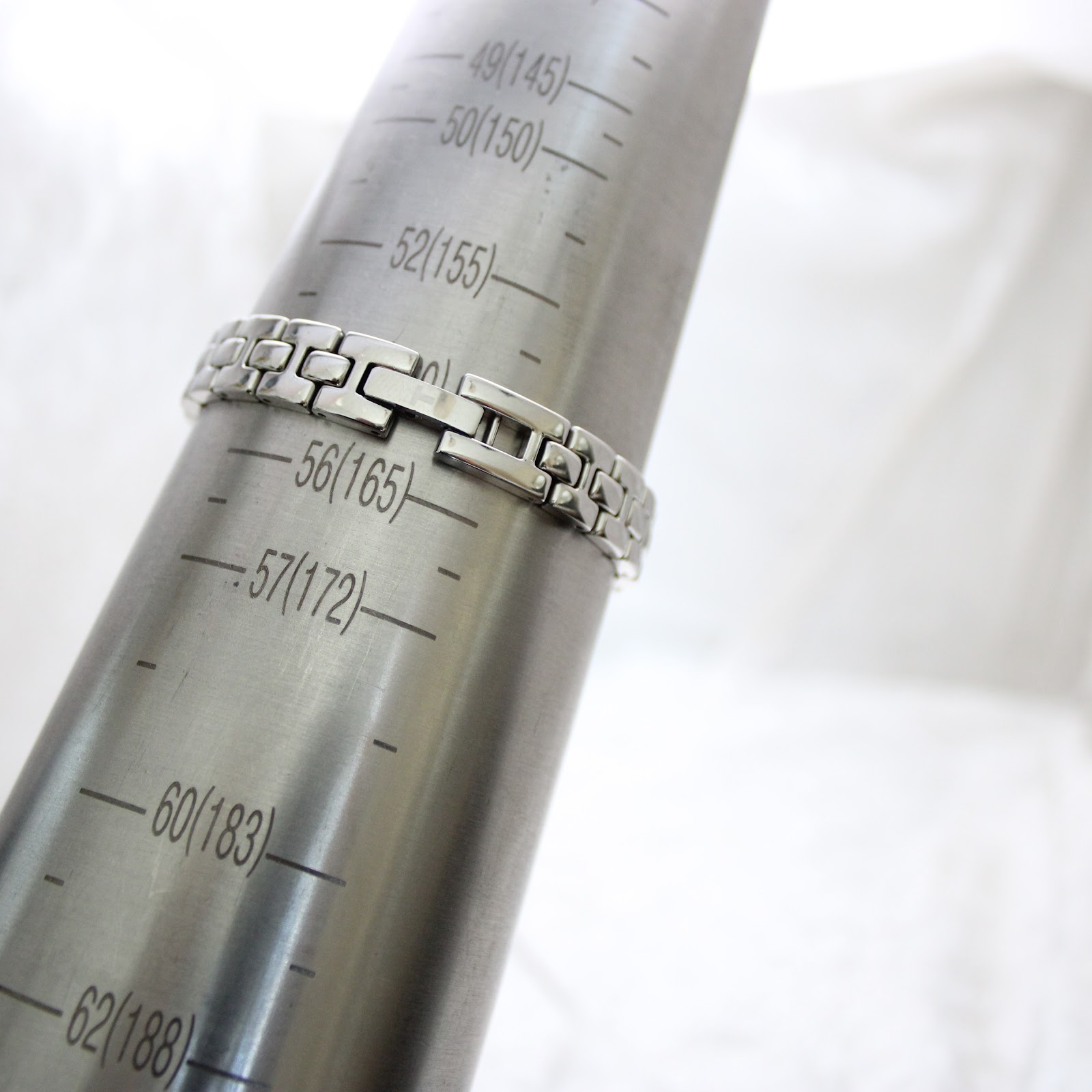 The Tissot G334 watch bracelet wrapped around a metal wrist sizing gauge, indicating a maximum wrist circumference of approximately 160mm.
