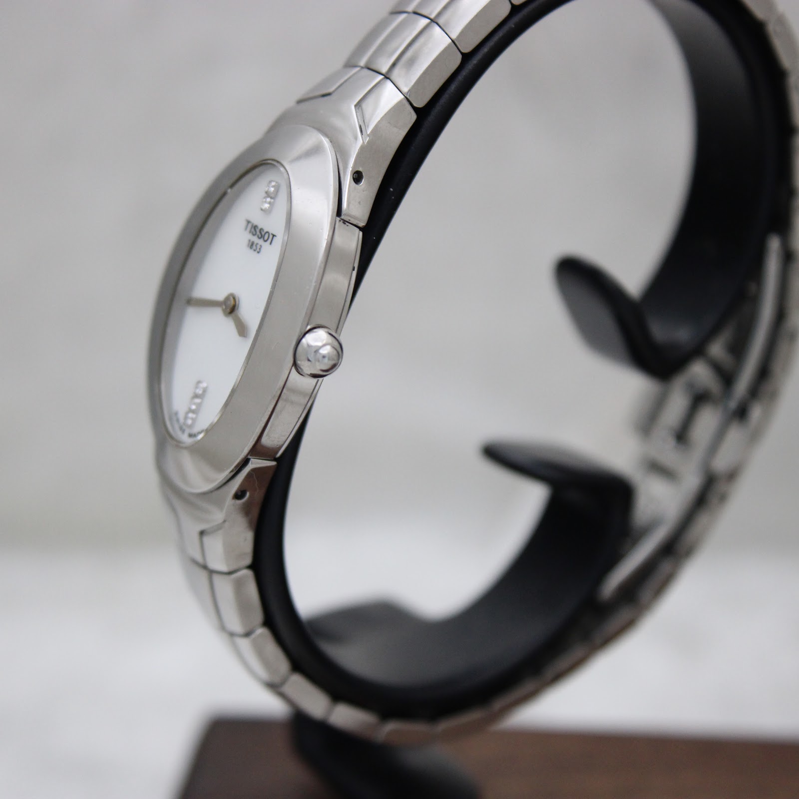 Side view of the Tissot L720 watch, showing the oval stainless steel case and integrated bracelet.