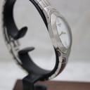 Angled side view of the Tissot L720 watch, highlighting the polished steel finish and sapphire crystal.