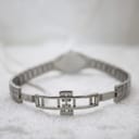 Close-up of the deployment clasp on the Tissot L720 stainless steel integrated bracelet.