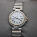 Front view of Dunhill two-tone quartz watch with white roman numeral dial on grey surface.