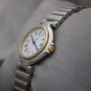 Angled view of Dunhill watch showing the side profile and gold-tone fluted crown.