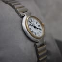 Another angled view of the Dunhill watch, highlighting the white dial and two-tone bracelet.