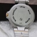 Close-up of the watch case back, showing 'Swiss Made Quartz Water Resistant' engraving and serial number '12 50223'.