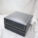 Close-up of the closed Dunhill original presentation box with gold trim.