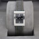Front view of Christian Dior D78-109 watch on grey display cushion, black dial in rectangular stainless steel case with denim strap.