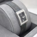 Different angled view of Dior D78-109 on cushion, highlighting the polished steel case and minimalist black dial.