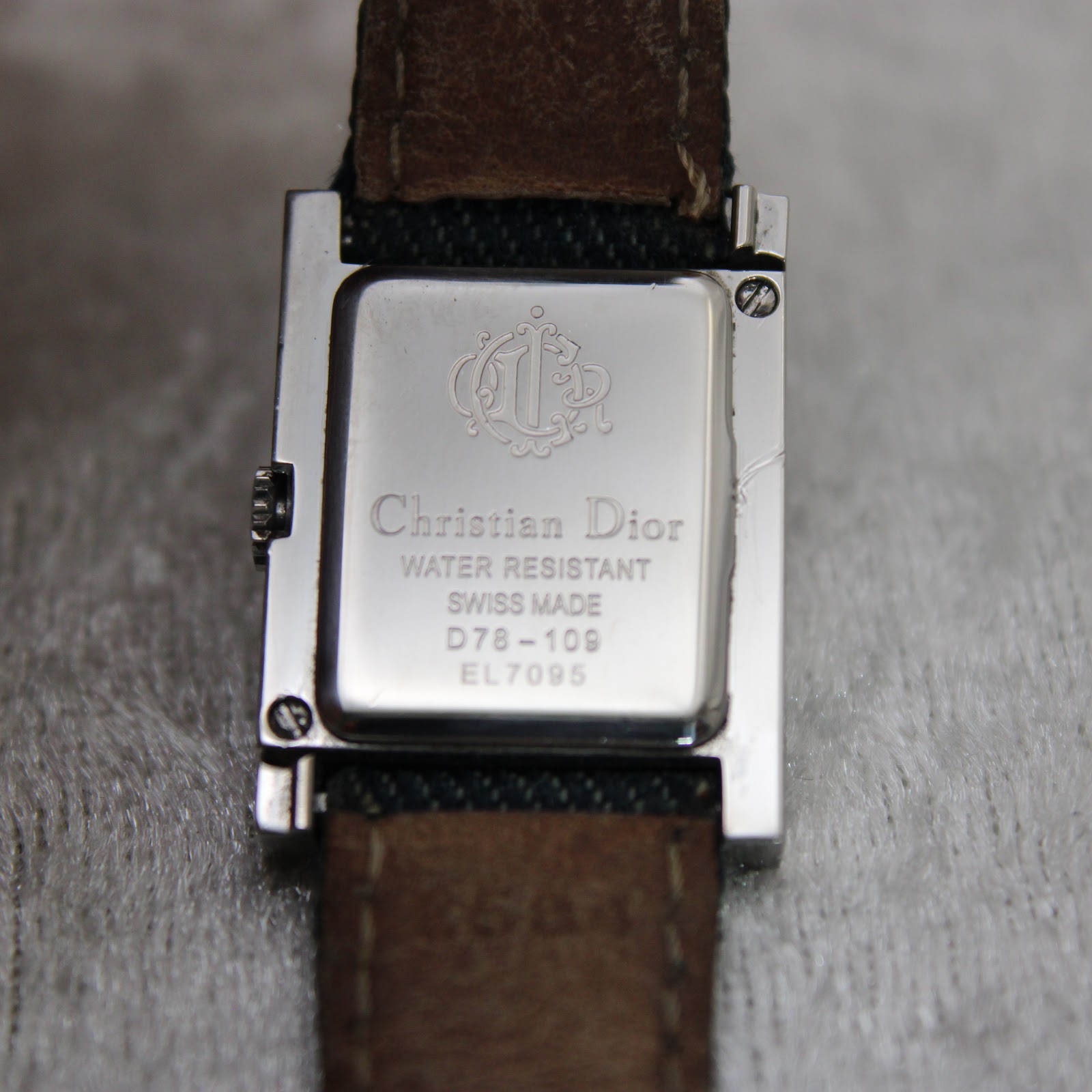 Close-up of the polished stainless steel case back with "Christian Dior", "Swiss Made", "Water Resistant", and model D78-109 engravings.