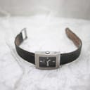 Full view of the Dior D78-109 watch with the denim strap unbuckled, on a white surface.