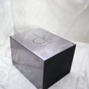 Top view of the black Calvin Klein watch box, featuring the 'ck Calvin Klein swiss made' logo on the lid.