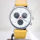 Front view of Mercedes-Benz SLK chronograph with white dial, black subdials, red hand, and yellow leather strap.