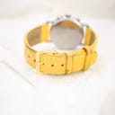 Close-up of the yellow leather strap and gold-tone buckle of the Mercedes-Benz SLK watch.