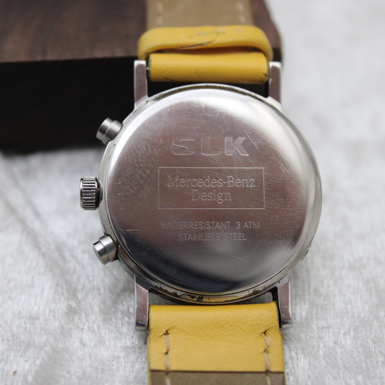 Back view of the stainless steel case of the Mercedes-Benz SLK watch, showing 'SLK Mercedes-Benz Design water resistant 3 ATM stainless steel' engraving.