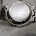 Close-up of the polished stainless steel case back of the Gucci 9000G, with 'water resistant to 3 atm', '9000G', serial number, and Gucci crest engraving.