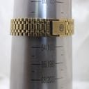 The gold-tone Gucci bracelet on a wrist sizing gauge, indicating a wrist circumference of approximately 190mm (19cm).