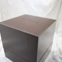 Top-down view of the closed brown Gucci watch box with the 'GUCCI' logo embossed on the lid.