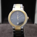Front view of Gucci 8900M two-tone watch with black dial and gold-tone hands, presented in its box.