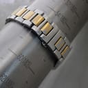 Close-up of the two-tone Gucci bracelet on a wrist sizing gauge, indicating a wrist circumference fit of approximately 17.2cm.