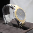 Another angled view of the Gucci 8900M, focusing on the two-tone case and bracelet details, resting in its box.
