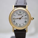 Front view of gold-tone Gucci 7200L with white dial and green Roman numerals on a dark brown leather strap.