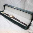The Gucci 7200L watch neatly presented inside a dark green display box with a contrasting light interior.