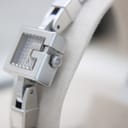 Side view of the Gucci 102 G-frame watch case and crown, showing the 'G' logo on the crown.
